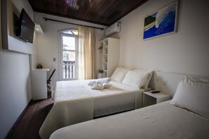 Standard Triple Room | Minibar, desk, laptop workspace, blackout curtains