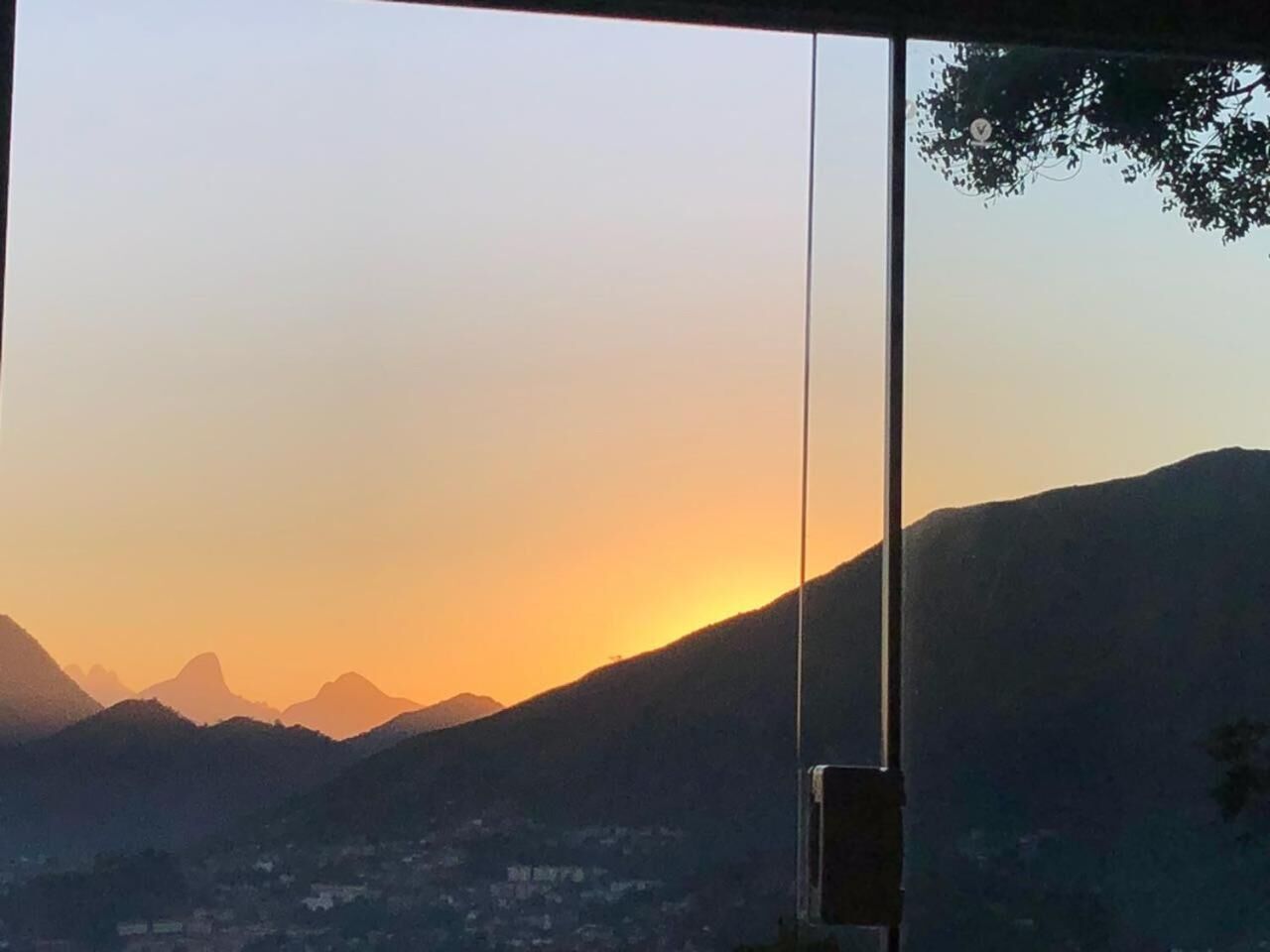 A view of a mountain range at sunset with a clear sky.