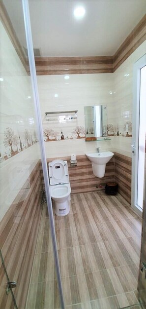 Shower, designer toiletries, hair dryer, slippers