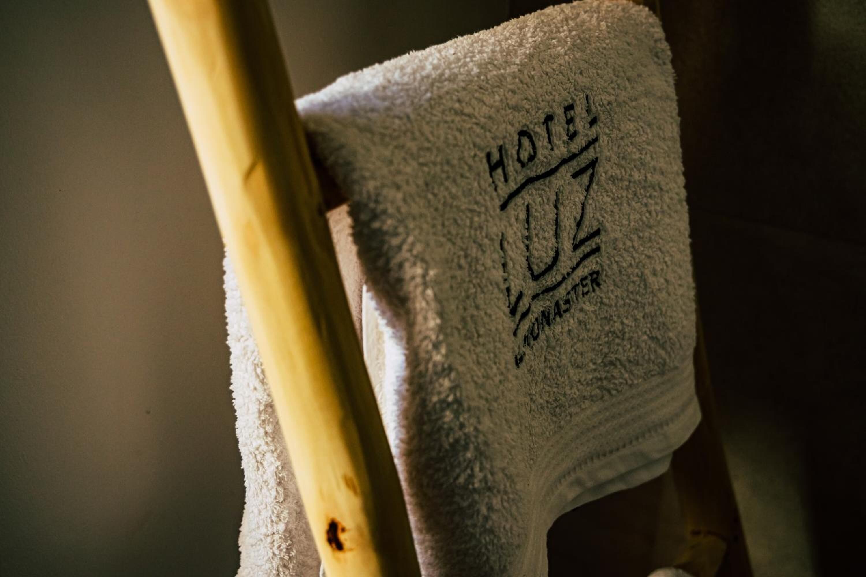 A towel with "HOTEL" and "UZ" embossed on it.