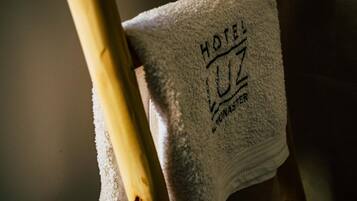 A towel with "HOTEL" and "UZ" embossed on it.