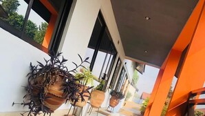 A modern building with large windows and a tiled floor. - Rexmar Hotel (Kumasi)