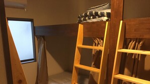 A bunk bed room with a window, curtains, and a wooden ladder. - Heart Hostel and Diner (Ise)