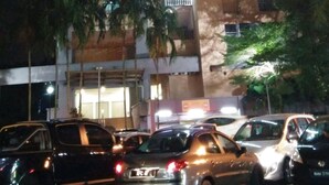 A multi-story building with balconies and a parking area in front. - Couchbee at Perdana Exclusive Condominium (Petaling Jaya)
