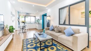A modern living room with a sofa, coffee table, and a large window.