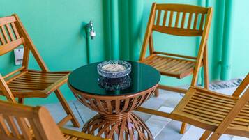 A round table with a glass bowl in the center, surrounded by wooden chairs.