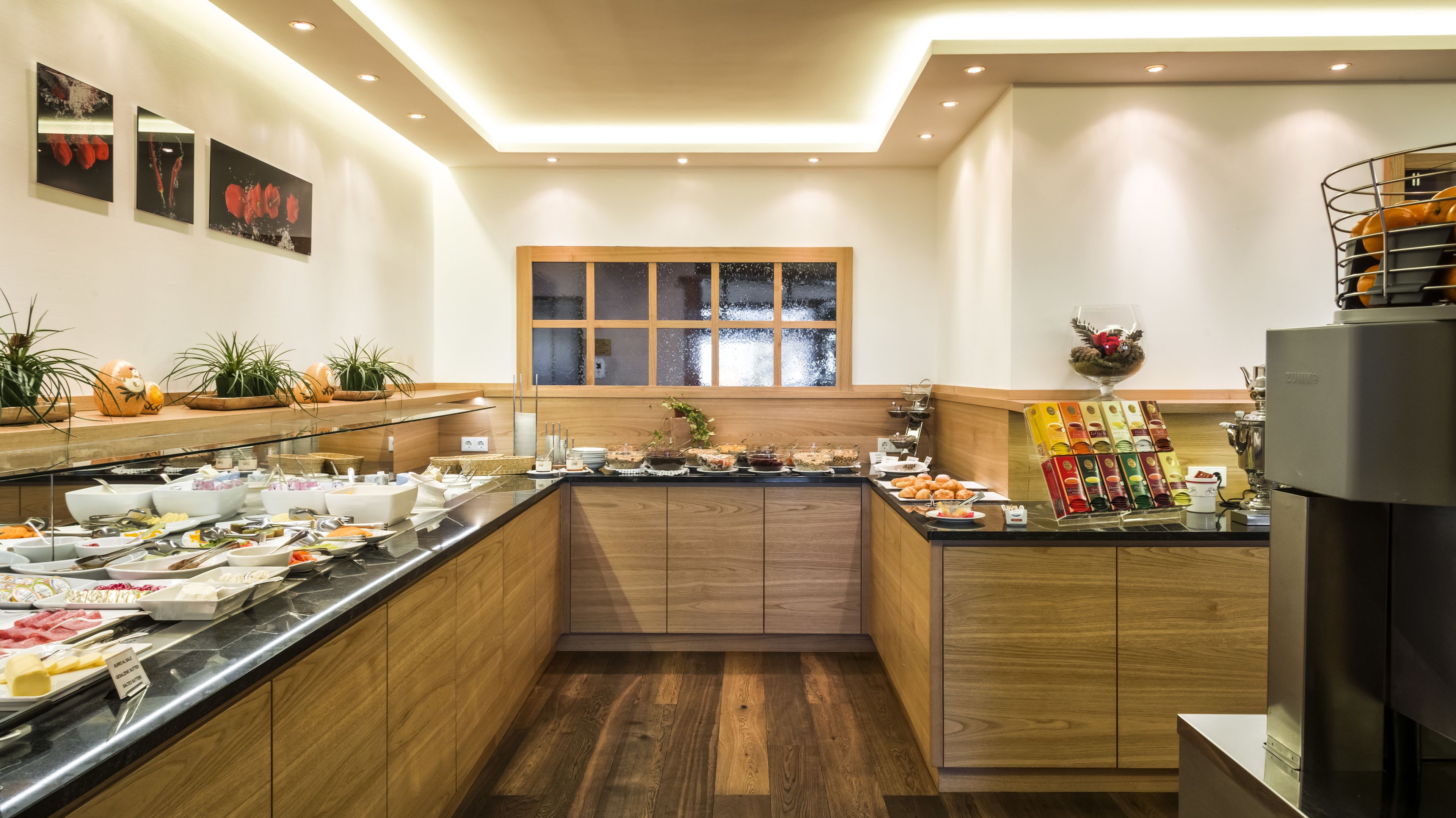 A buffet setup with various food items and a coffee station.