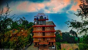 A two-story building with a sign reading "Golden Kuense Resort". - Golden Kuensel  Resort & Spa (Kalimpong)