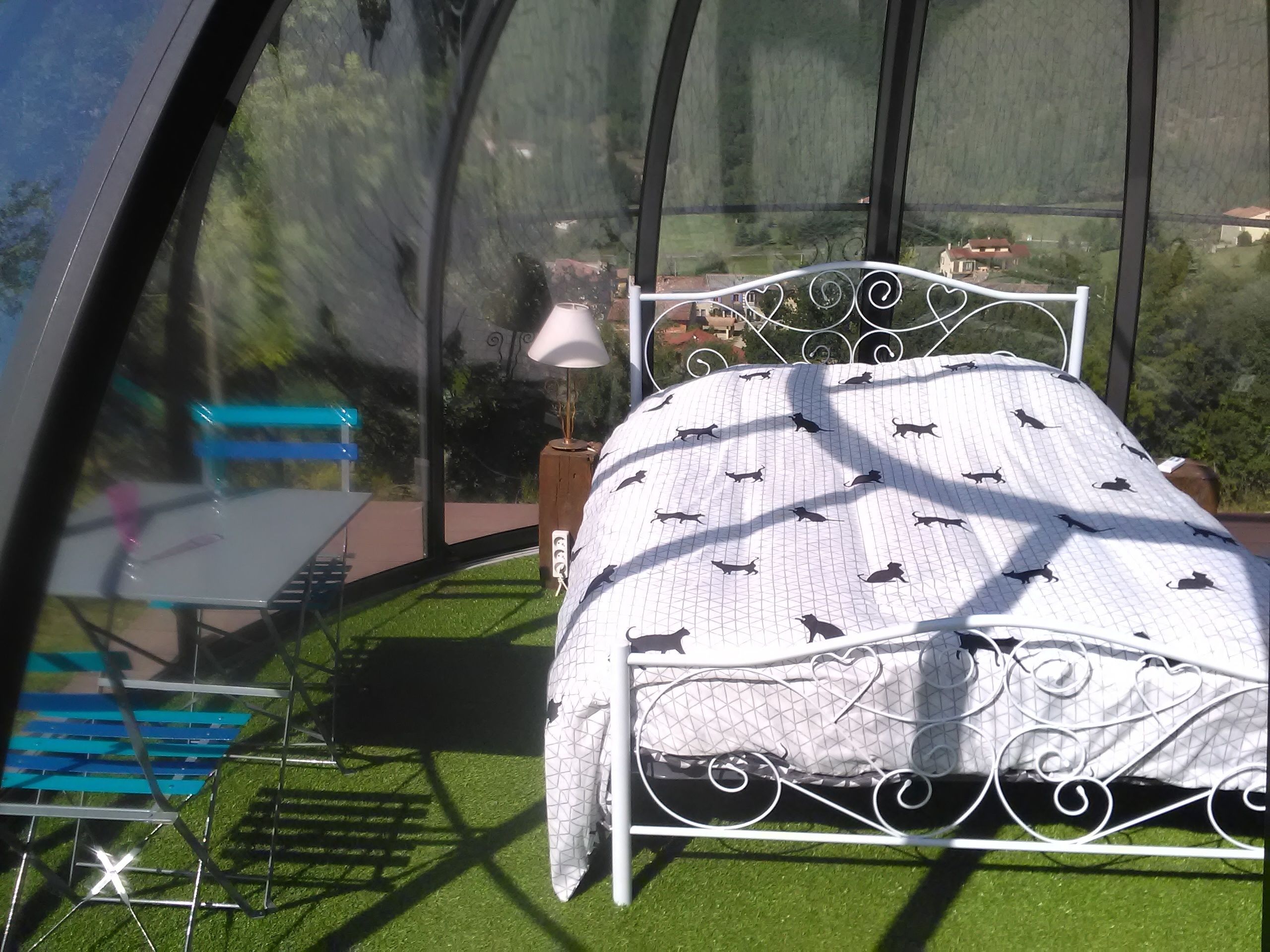 A room with a bed, a table, and a bench.