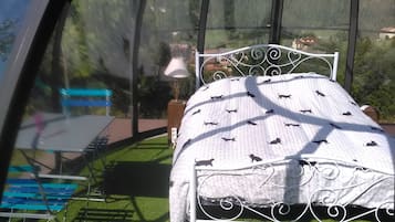 A room with a bed, a table, and a bench.