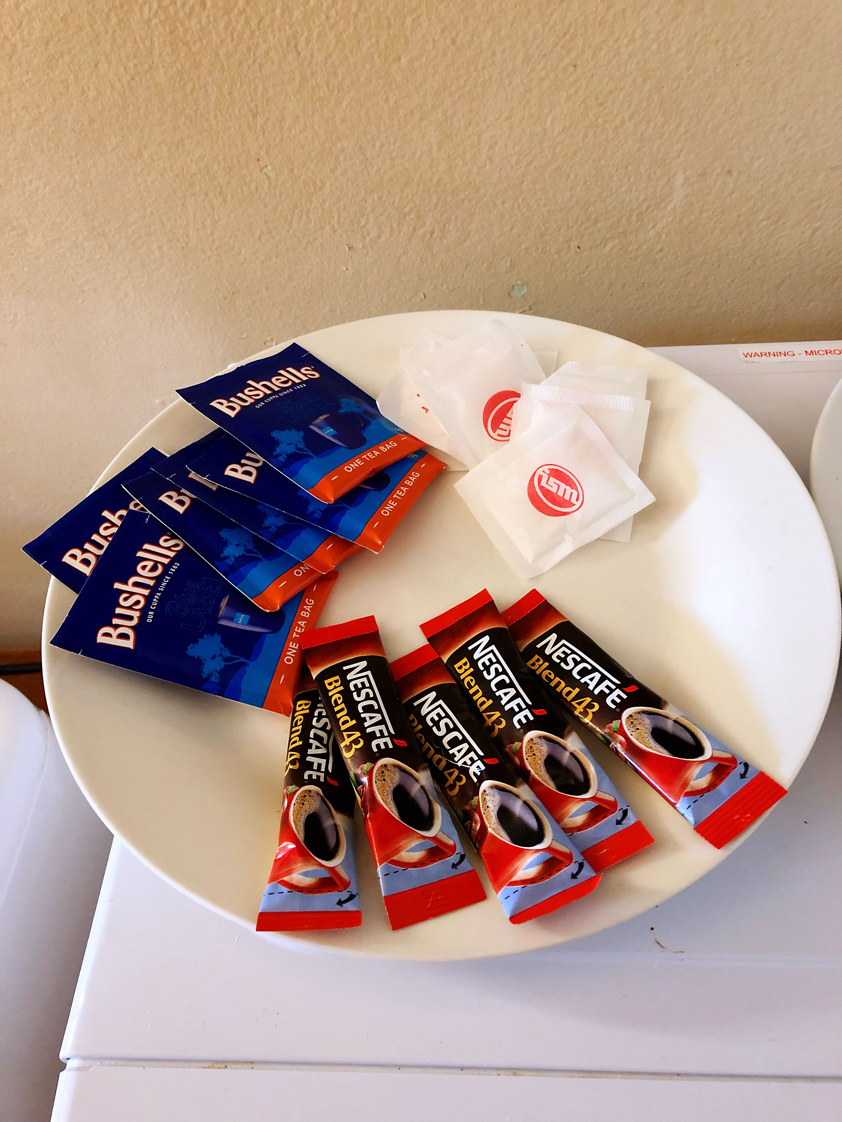 A plate with several tea bags and a warning label.