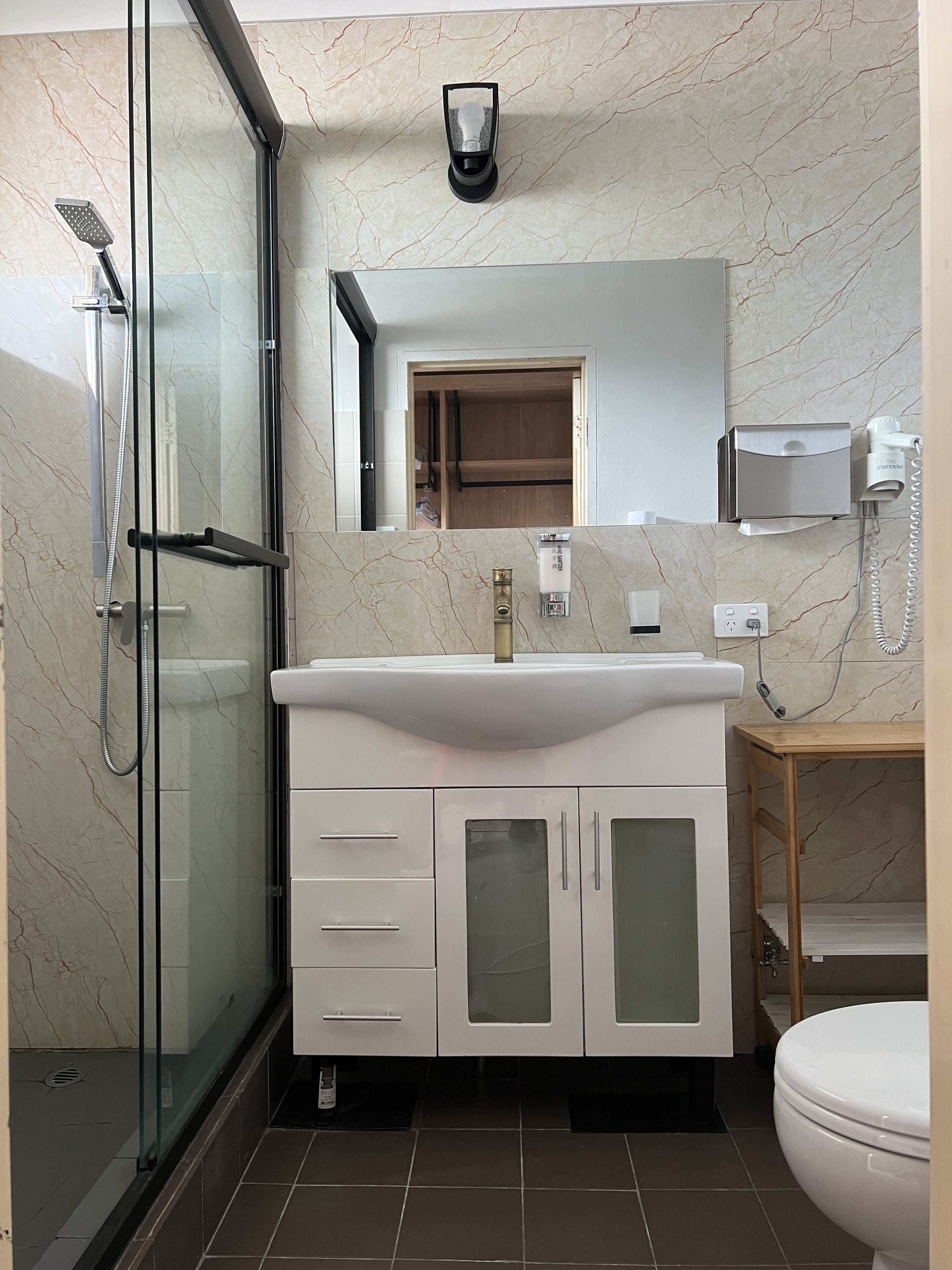 Shower, hair dryer, slippers, towels