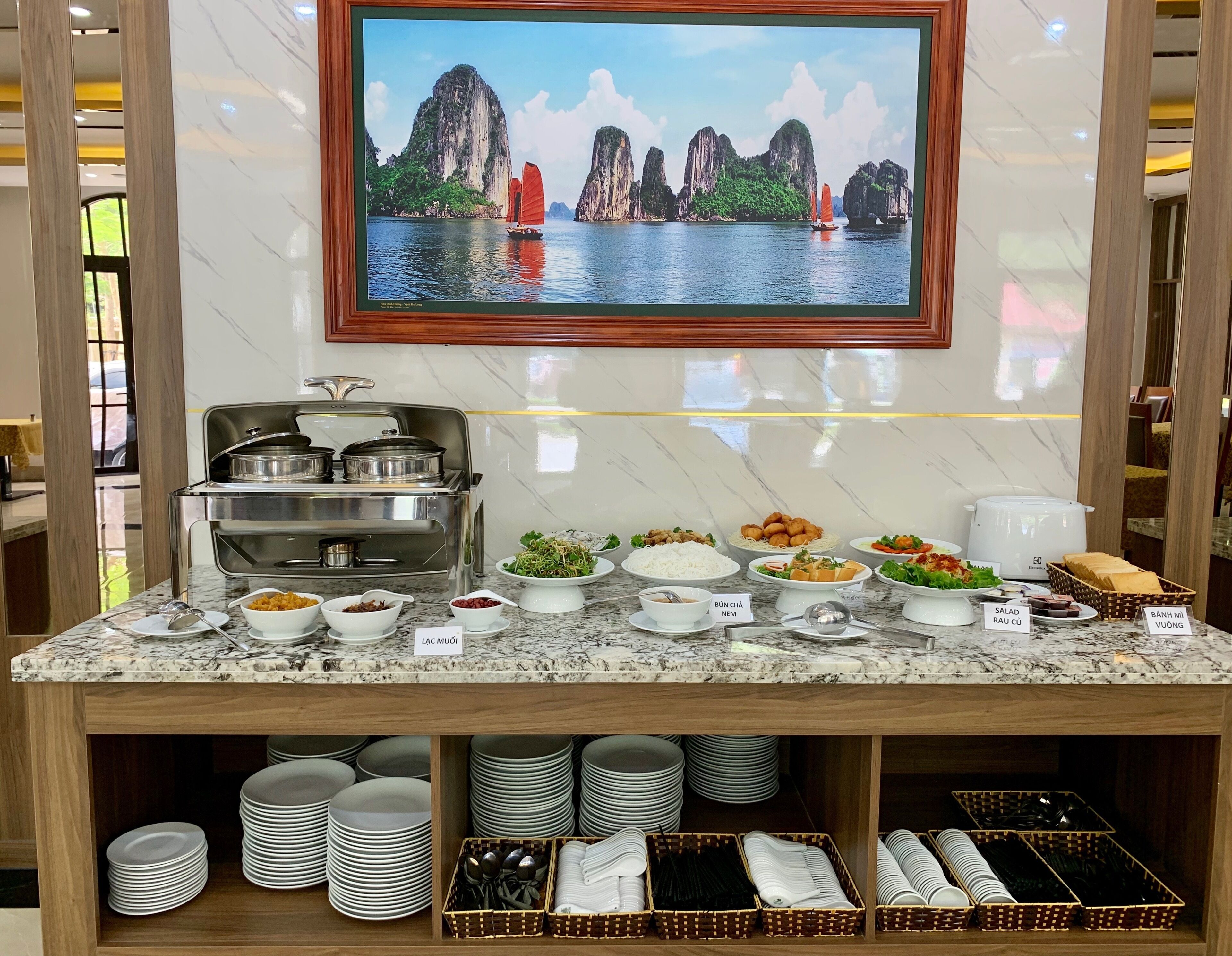 A buffet setup with various dishes and a stove.