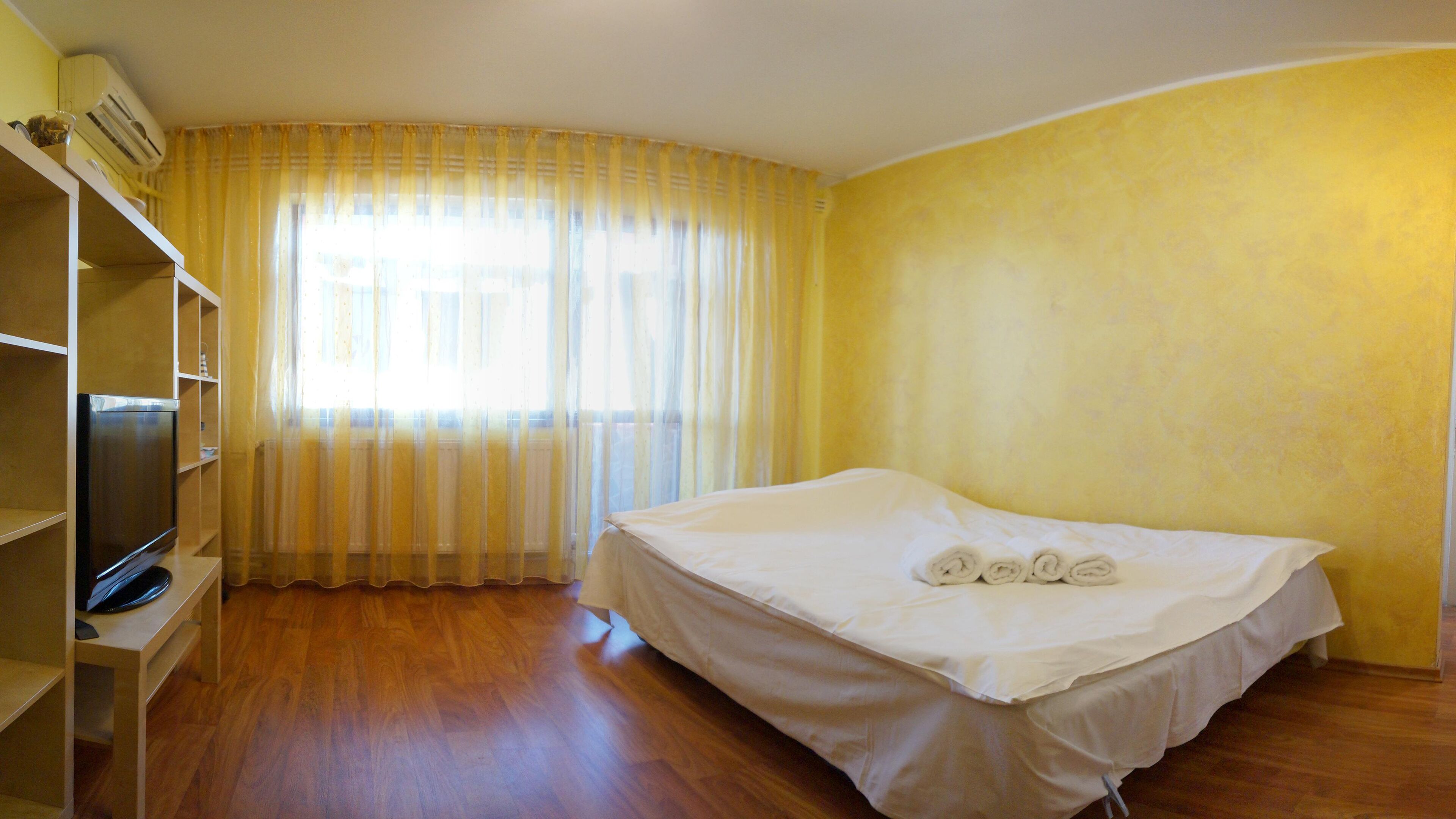 A room with a bed, a TV, and a wardrobe.