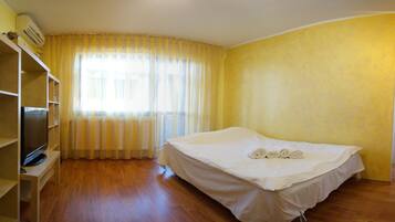 A room with a bed, a TV, and a wardrobe.