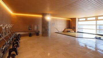 A spacious indoor area with a wet floor, indicating a recent cleaning or maintenance activity.