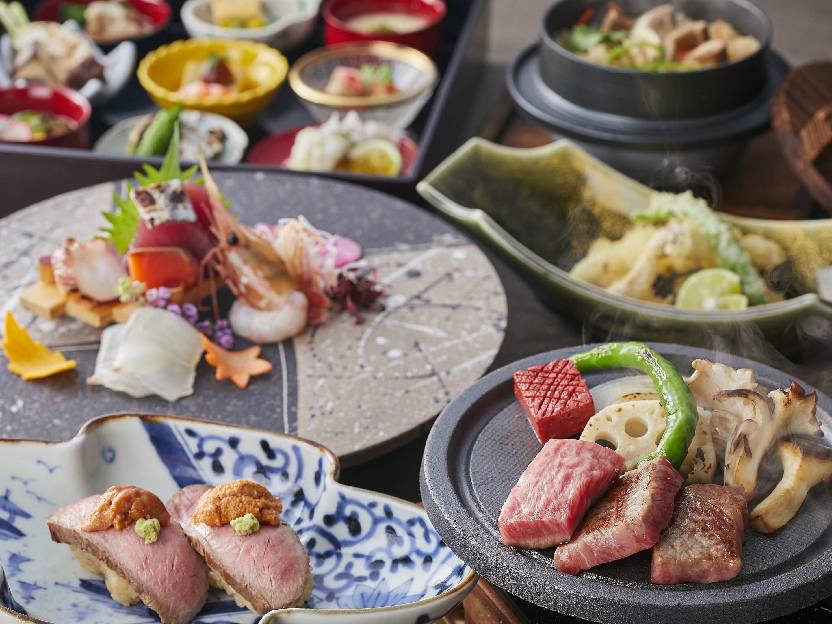 A variety of dishes including grilled meat, seafood, and vegetables, suggesting a diverse meal selection.