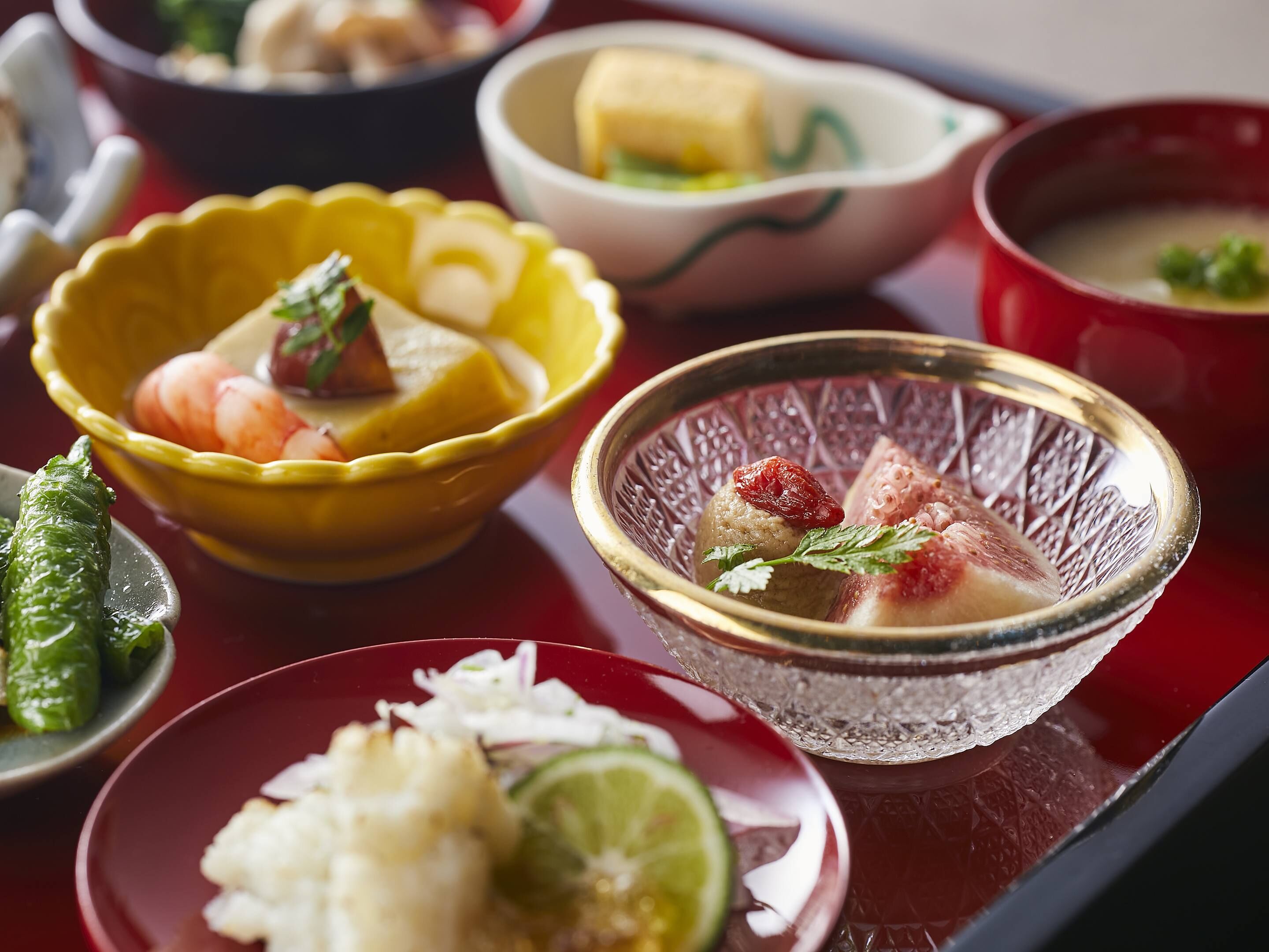 A variety of dishes in different bowls on a table.
