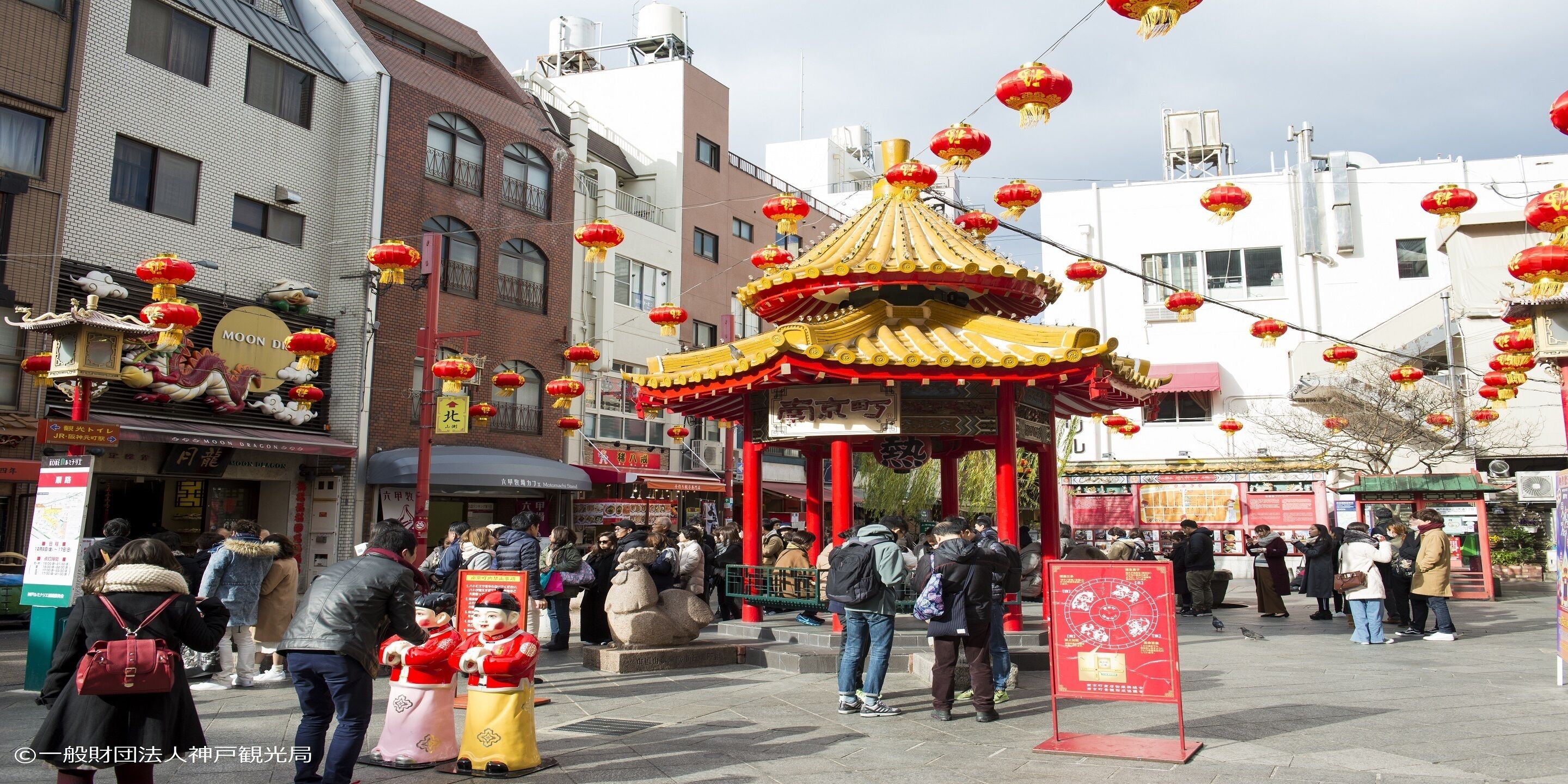 A traditional Chinese pavilion with red lanterns and a dragon decoration.