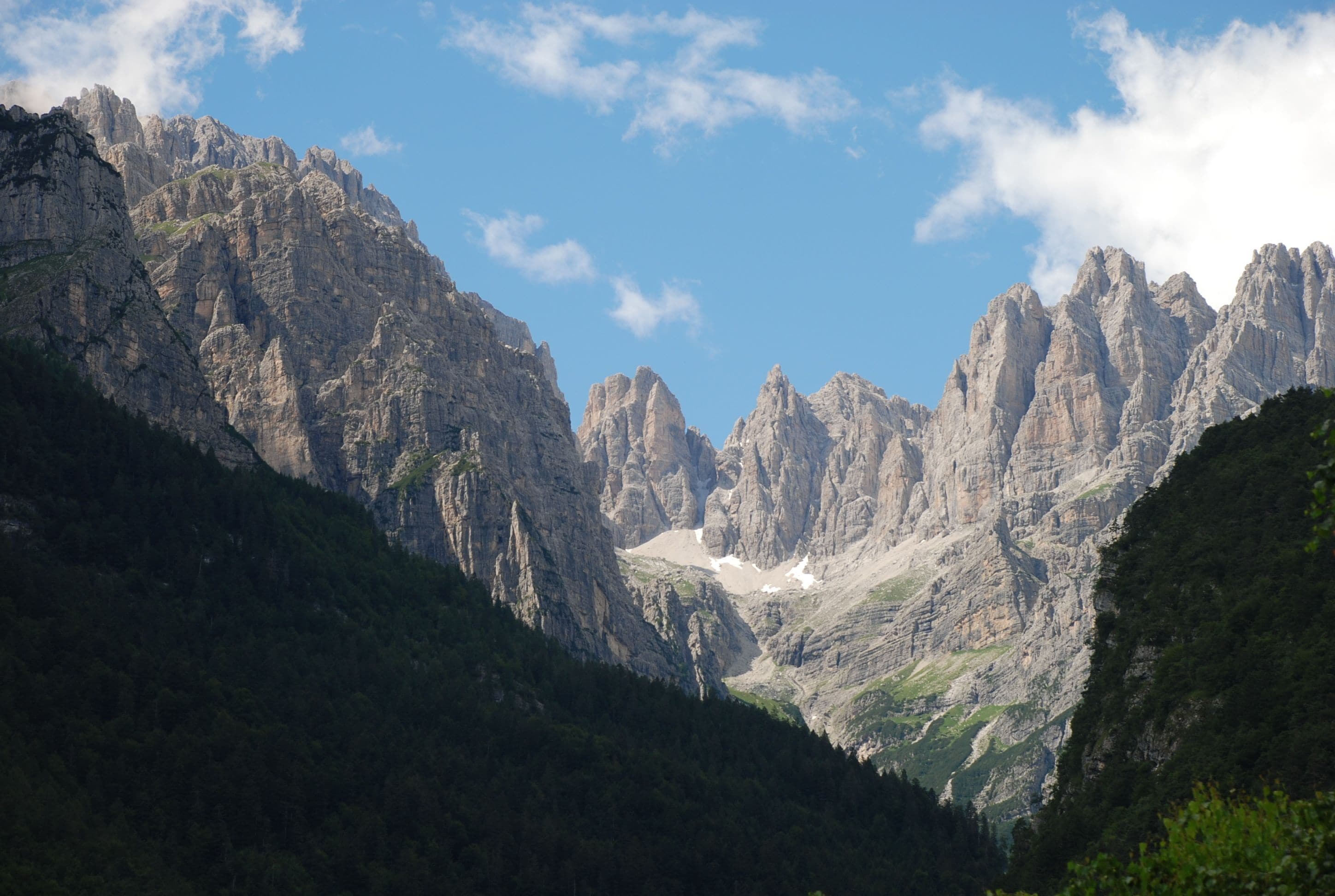 A mountainous landscape with rocky peaks and a valley.