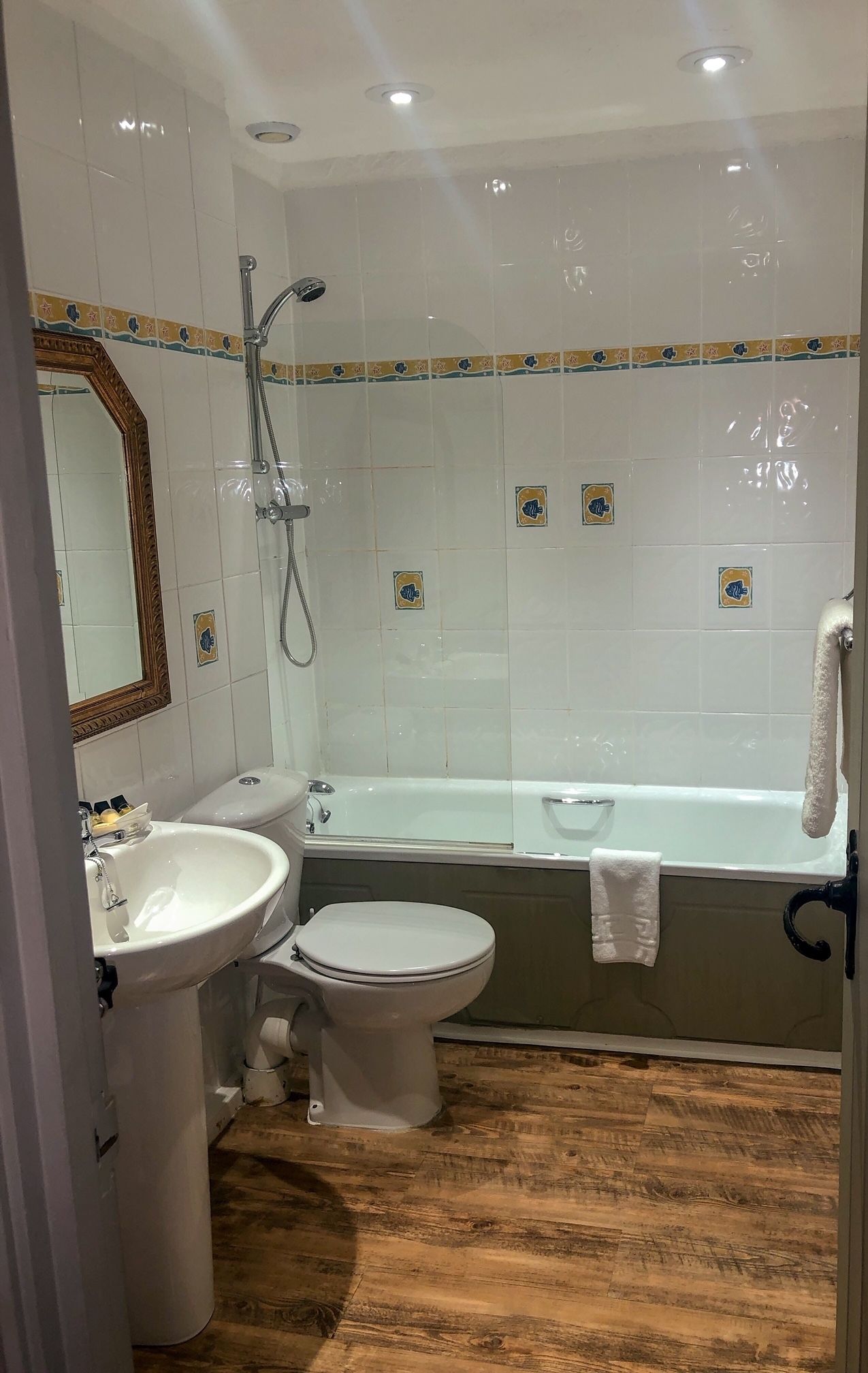 A bathroom with a bathtub, a toilet, and a sink.