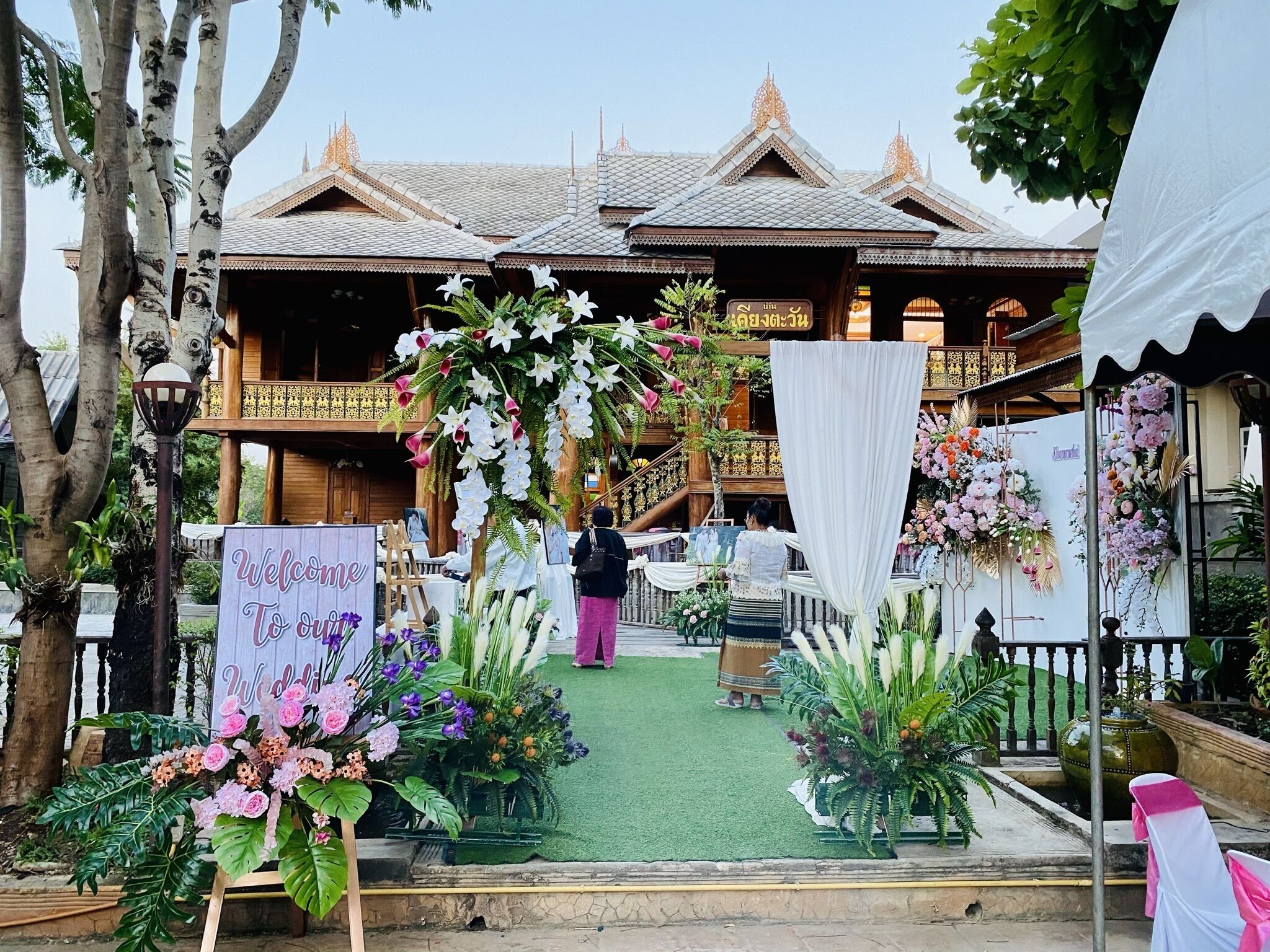 A traditional building with a wooden facade and a sign welcoming visitors.