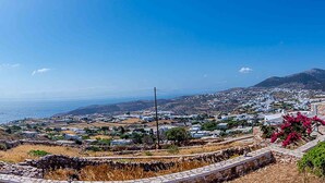A coastal town with stone walls, windmills, and a view of the sea. - Spacious 2 Bedroom House with Fantastic Yard (Sifnos)
