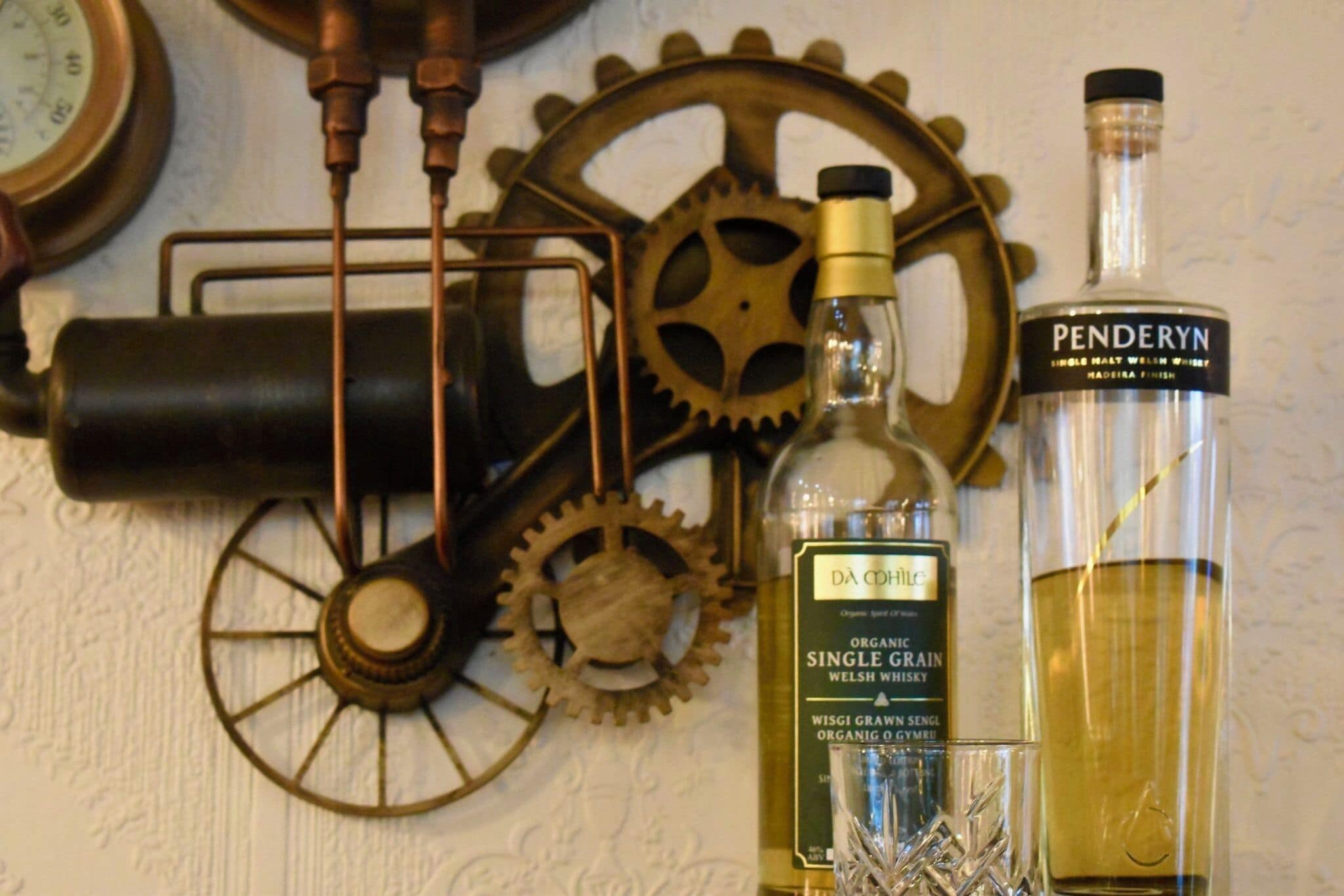 A bottle of Pendreyn single malt whisky, a bottle of Da Cwine single grain whisky, and a glass of whisky.