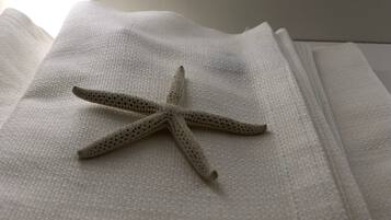 A starfish on a textured white surface.