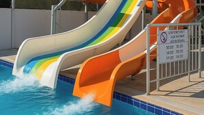 A water park with multiple slides and a pool. - Helen Troya Hotel Geyikli (Ezine)