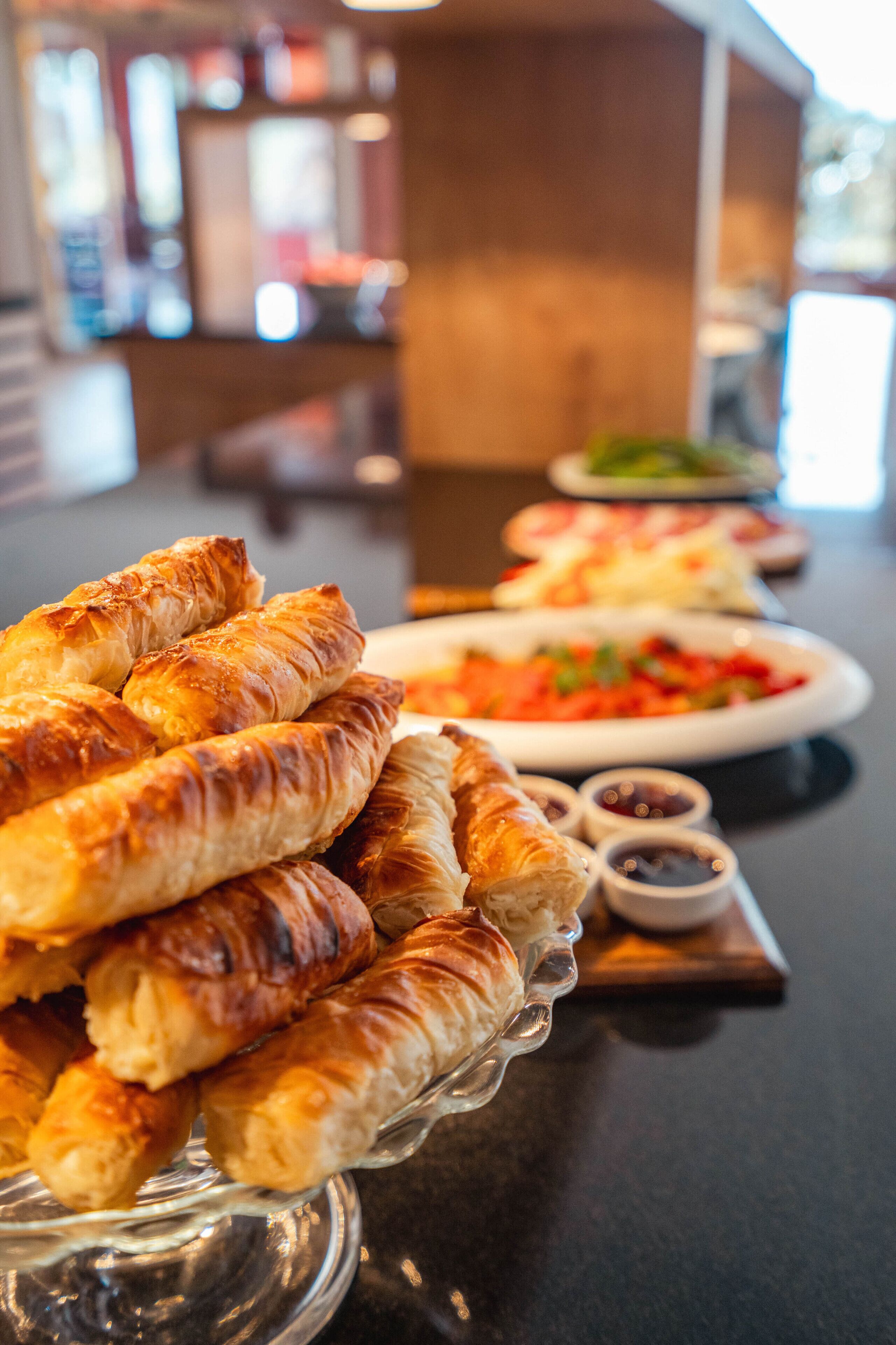 A buffet table with pastries and dishes.