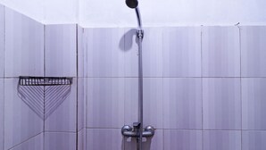 A shower with a handheld showerhead and a fixed wall-mounted faucet. - Aurelia House A Mini Apartment (Pekanbaru)