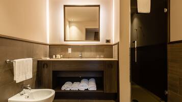 Une salle de bain moderne avec un lavabo, un miroir et un porte-serviettes.