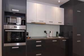 Deluxe appartement, hot tub | Privékeuken | Een koelkast, een magnetron, een oven, een kookplaat