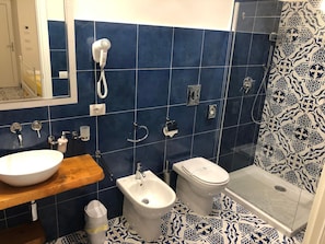 Un baño con lavabo, bidé, inodoro y ducha.