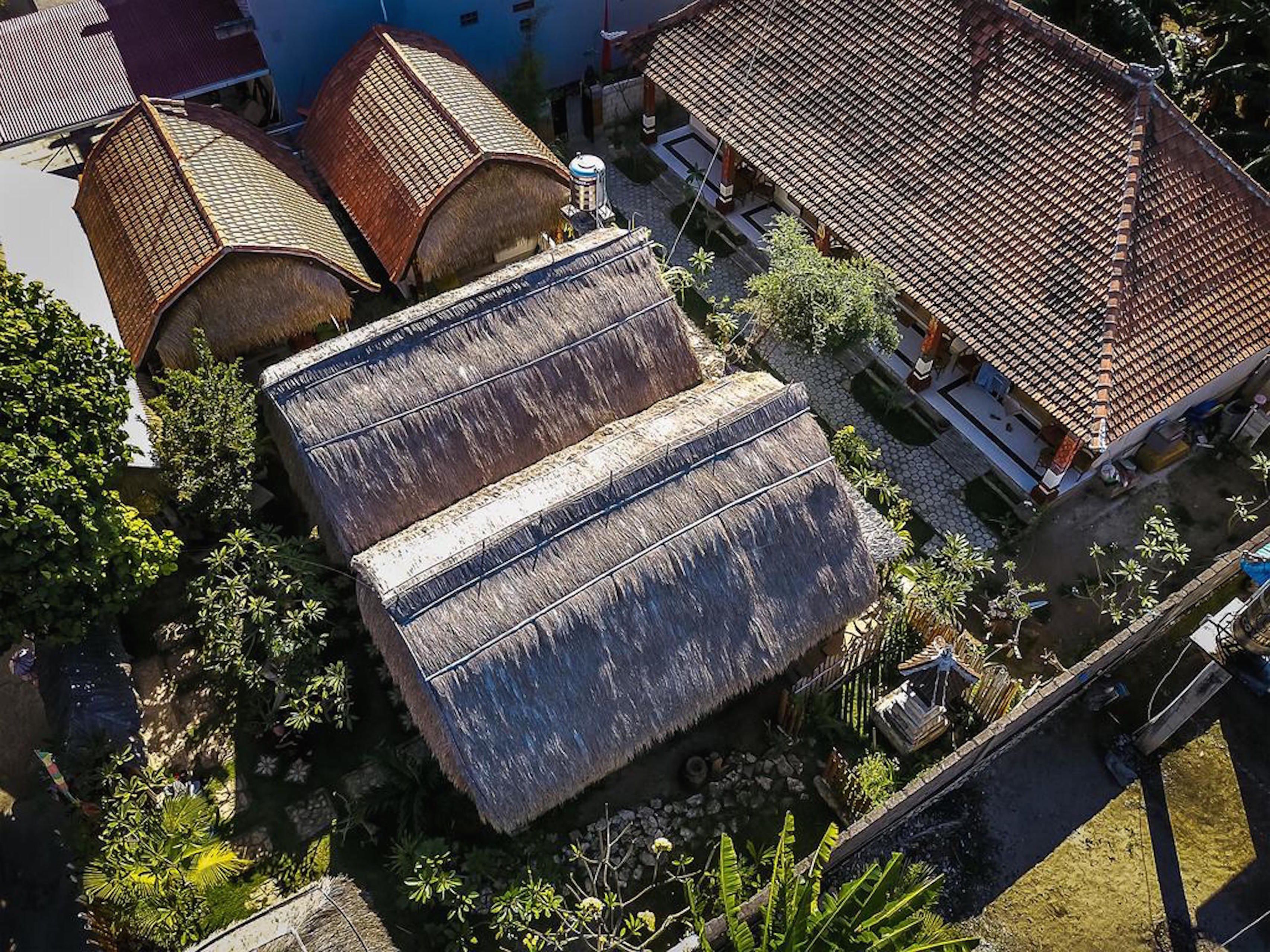 A traditional building with thatched roofs and a courtyard.