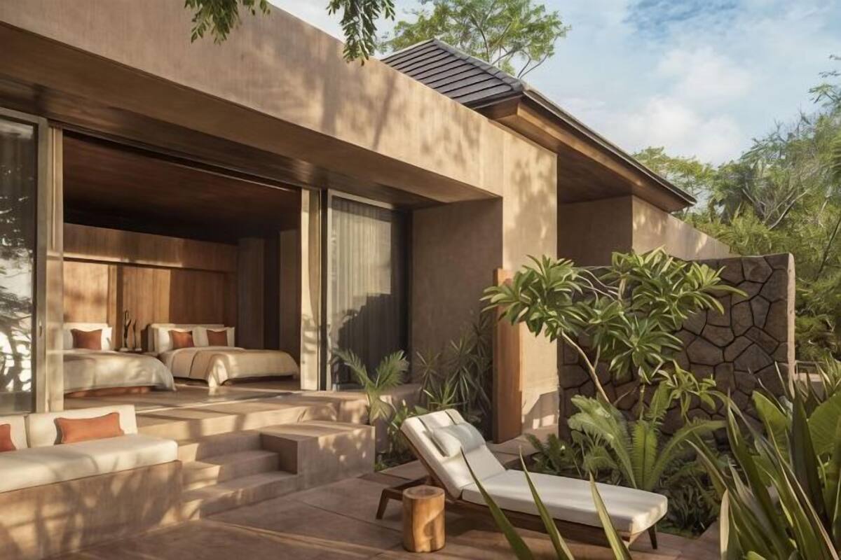 A modern house with a bedroom, a balcony, and a patio area.