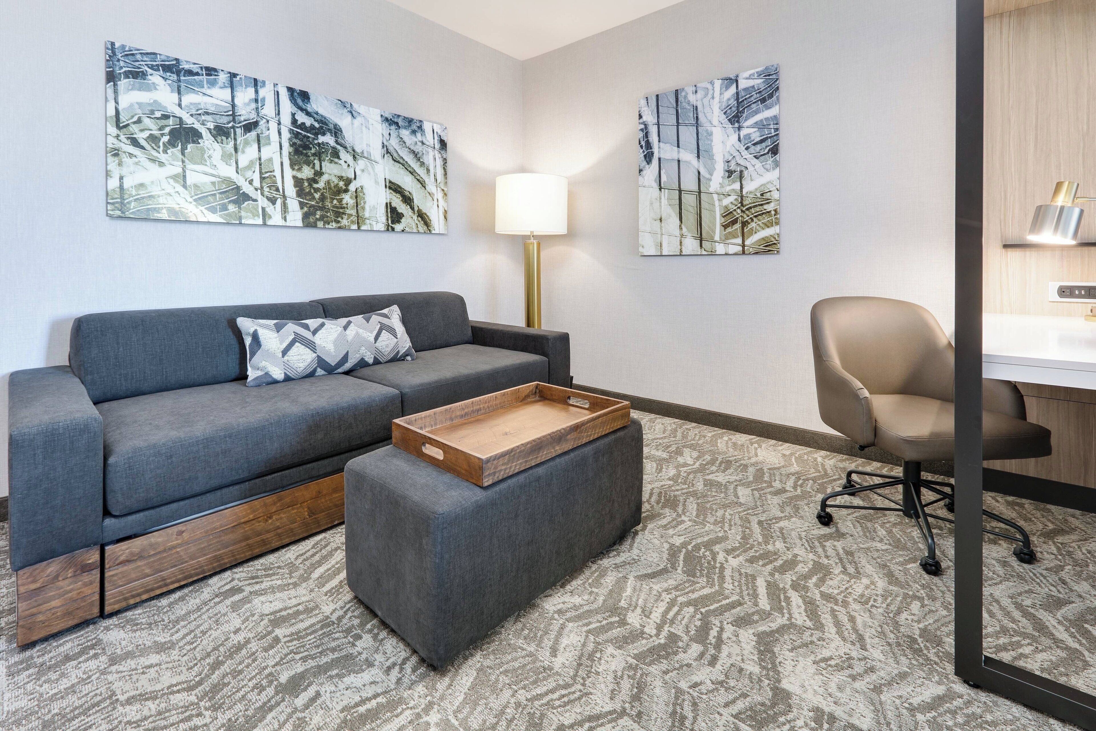 desk, laptop workspace, iron/ironing board, bed sheets