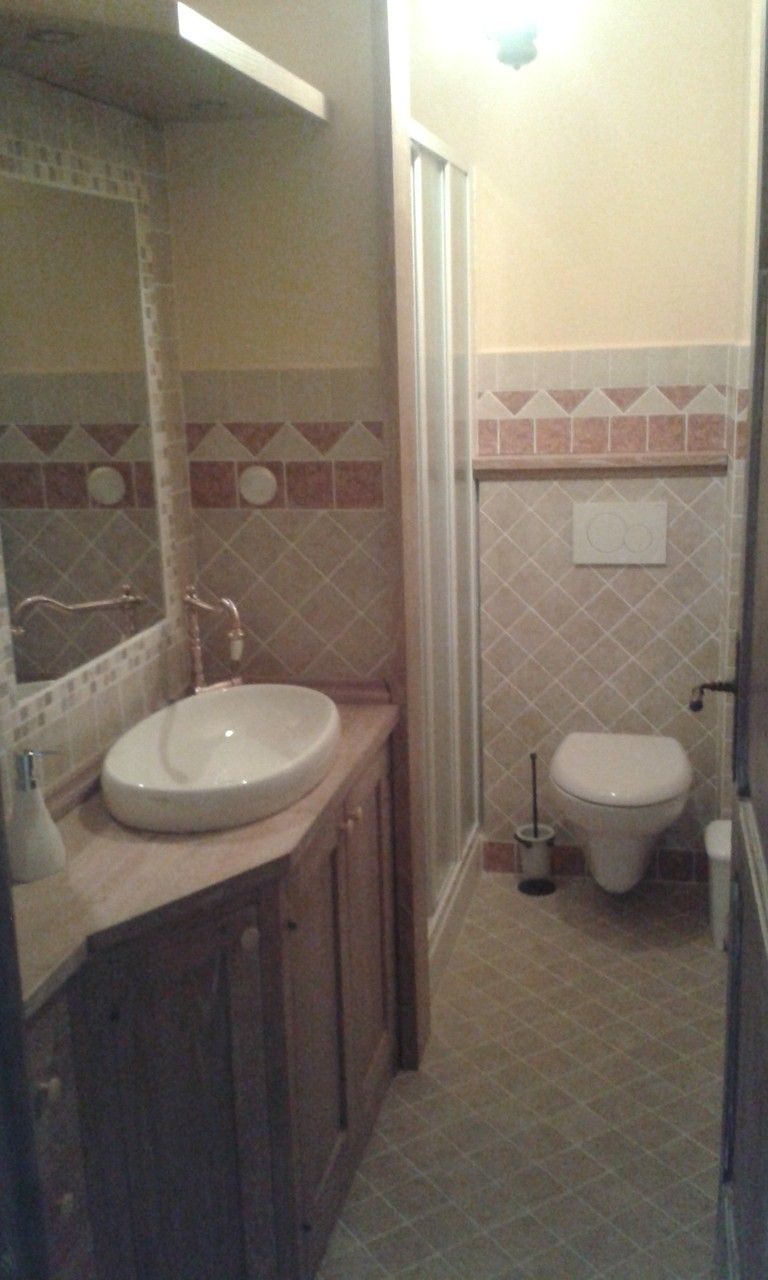 A bathroom with a sink, toilet, and shower.