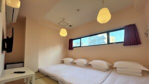A hotel room with a bed, a desk, and a window with curtains. - Hotel Hangout - Hostel (Osaka)