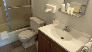 A bathroom with a toilet, sink, and shower. - Baw Beese Inn (Hillsdale)