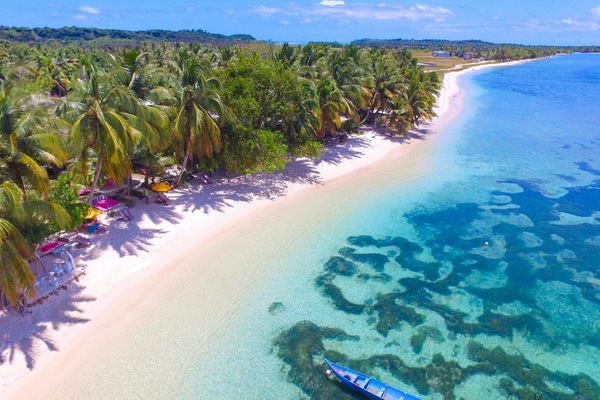 On the beach, white sand, sun loungers, beach umbrellas
