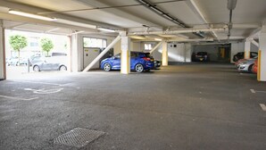 A multi-level parking garage with several cars parked. - The Reach (Liverpool)