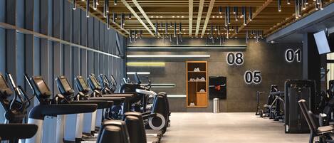 A gym with treadmills, ellipticals, and weight machines.
