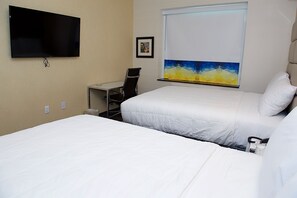 A hotel room with two beds, a desk, a chair, a flat-screen TV, and a painting on the wall. - 7 Days Hotel Bronx (Bronx)