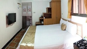 A bedroom with a bed, a television, a wardrobe, and a window with curtains. - Wu Feng Homestay (Jinning)