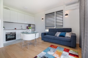 Superior Apartment | Living area | Flat-screen TV