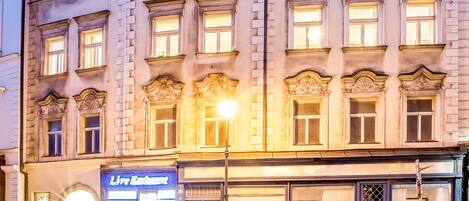 A building with a classic architectural style, featuring multiple windows and a sign for 'Live Exchange'.