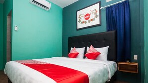 A bedroom with teal walls, a black headboard, and a bed with red and white bedding.