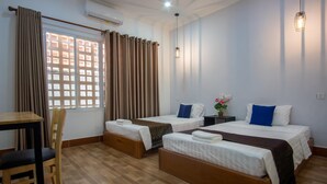 A hotel room with two single beds, a wooden desk, a chair, and a window with curtains. - 333 HOSTEL, Siem Reap (Siem Reap)